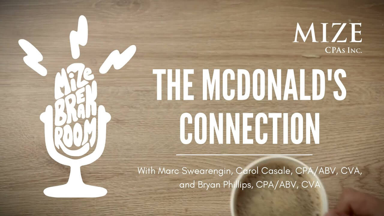 Coffee cup with the text The McDonald's Connection with Marc Swearengin, Carol Casale CPA/ABV, CVA and Bryan Phillips, CPA/ABV, CVA and the Mize Breakroom microphone logo made from the words Mize Breakroom